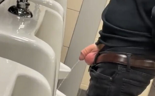 Guy caught taking a leak at urinals