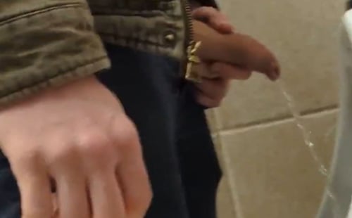 Uncut guy with lot of foreskin peeing at urinals