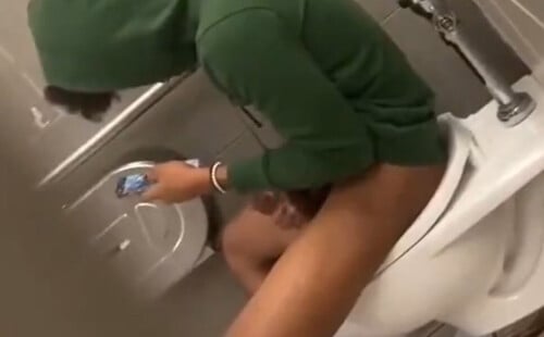 Latin guy stroking his hard dick in a public toilet