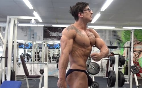 Huge dick bodybuilder showing off in tight posing trunks