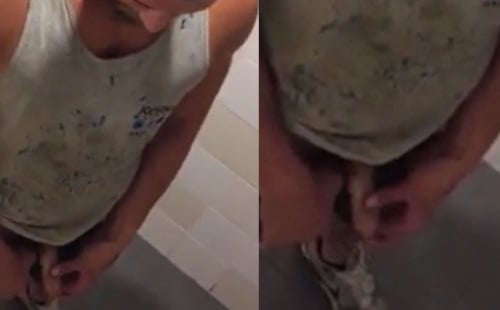 Bearded dude peeing in a public toilet