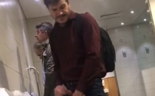 Handsome man caught peeing and shaking his cock