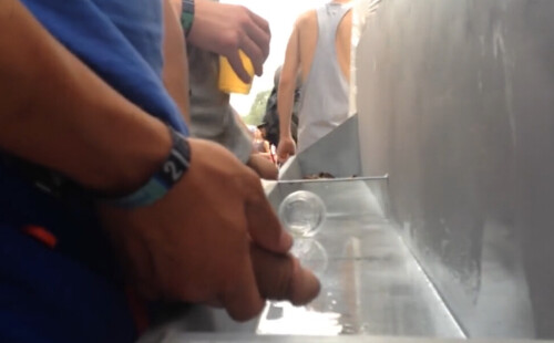 Very hung guy caught peeing at festival urinals