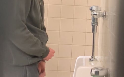 Sexy guy caught taking a leak at urinals