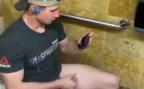 Muscled jock caught wanking in a public toilet