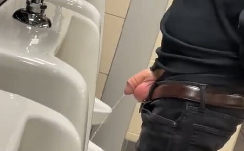 Guy caught taking a leak at urinals