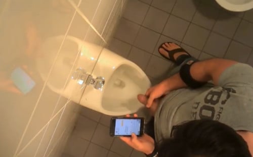 Guy caught peeing in a restroom