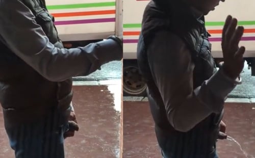 A cute drunk guy relieves himself in the street