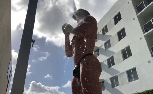 Bodybuilder taking a public shower