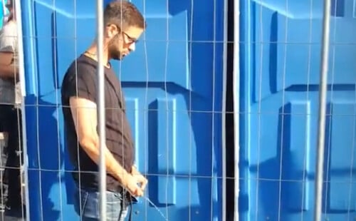 Handsome guy caught peeing in public during festival