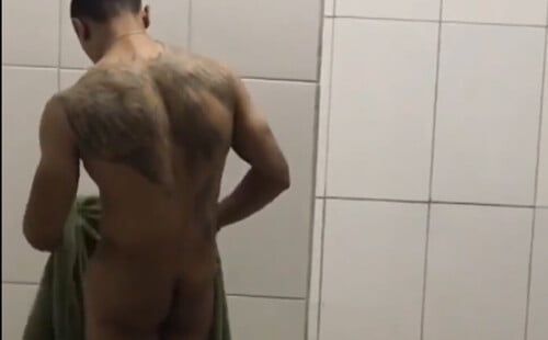 Tattooed guy caught naked in locker room by spycam