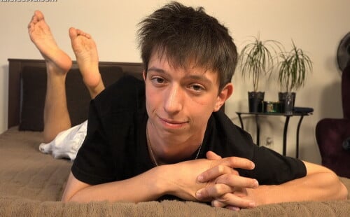 Lovely lad displays his bare feet in full detail