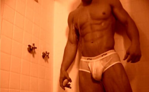 Muscled sexy guy taking a shower in undies