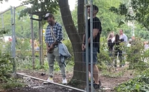 Guys peeing in public at the music festival