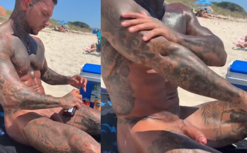 Tattooed stud putting sun cream at the beach