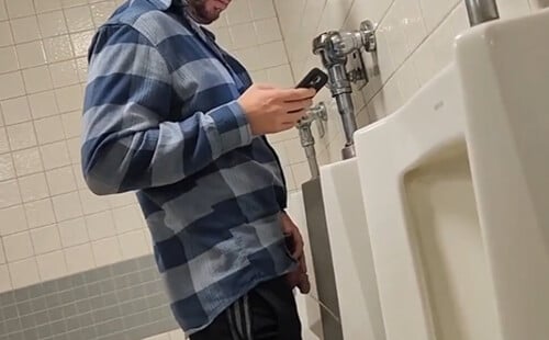 Man with big dick taking a pee at urinals