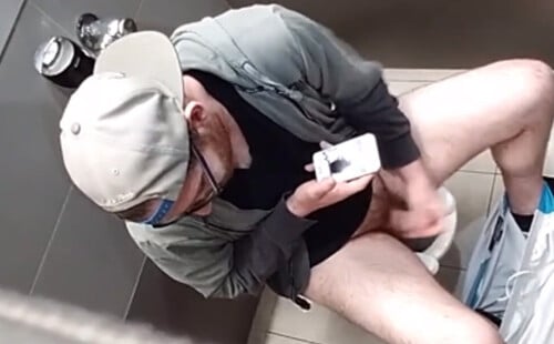 Horny ginger guy caught wanking in public toilet