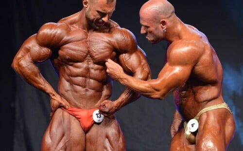 Bodybuilders touching each other on stage