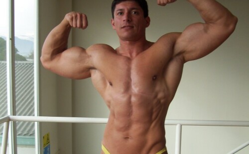 Straight latino bodybuilder in thong-like posing trunks
