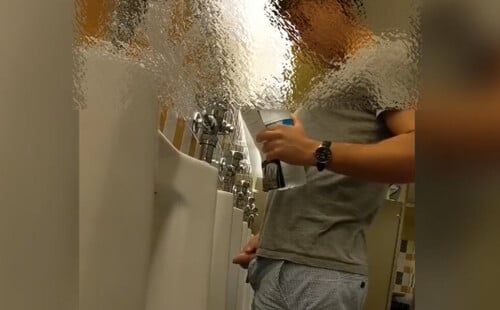 Uncut lad taking a pee in the restroom