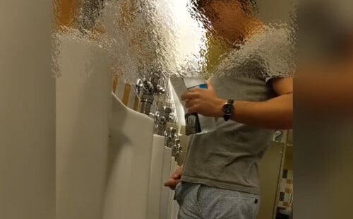 Uncut lad taking a pee in the restroom